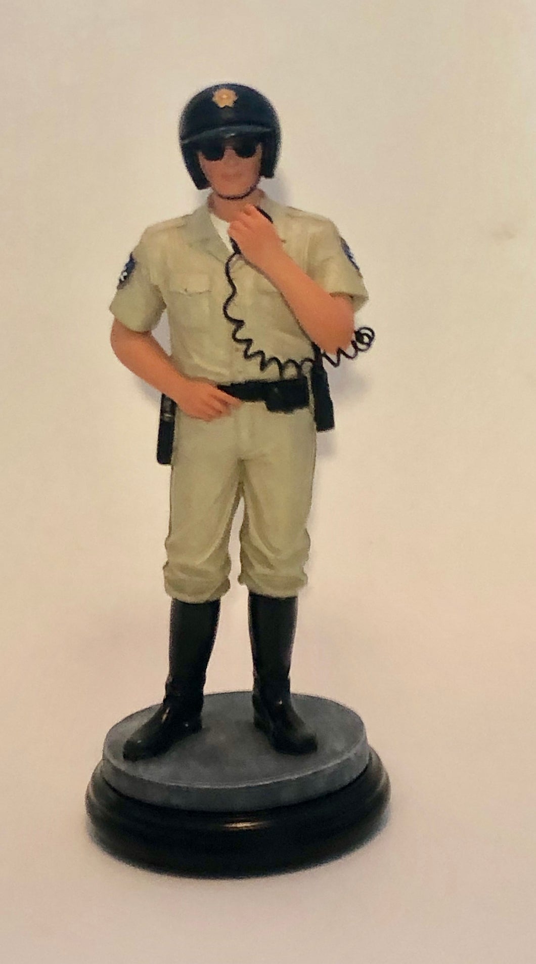 Standing Police Officer figurine on hand radio